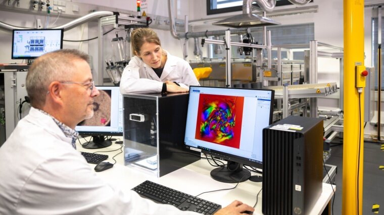 Scientists working on a computer in the lab