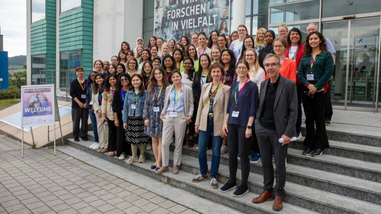 Attendees and hosts of the 2025 Women in Photonics workshop pose for a group photo.