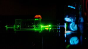 In the "pigtailing” process, fiber-optic cables are permanently fused to an integrated-optical quantum device.